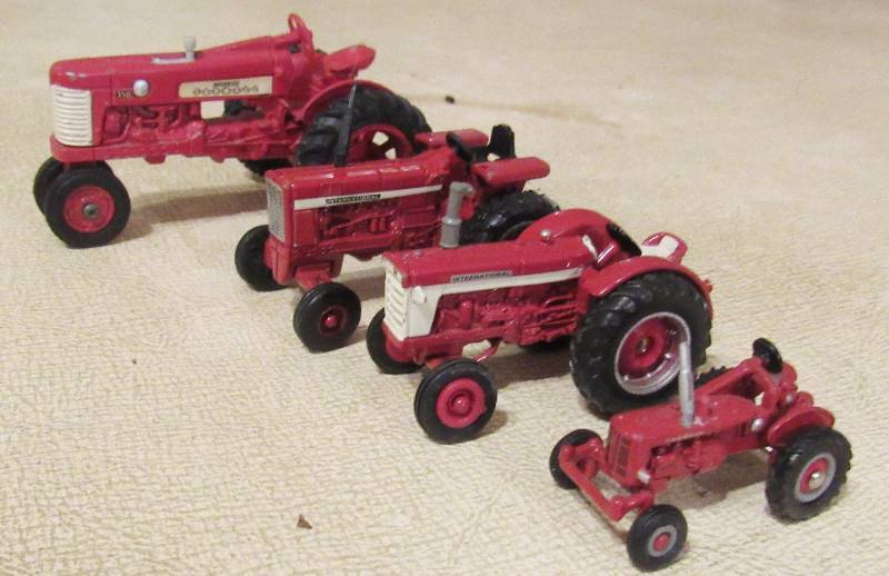 lot 7017 image: Lot of 4 - Red Die Cast Metal Tractors - various brands and conditions - see description and photos