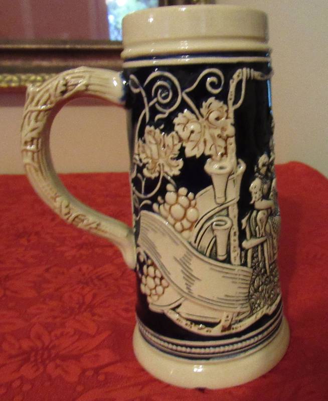lot 7983 image: Ceramic Beer Mug - Intricate Design w group of people and leaves - Neato