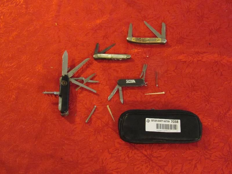 lot 7038 image: Lot of 4 Pocket Knifes - Swiss Army Knife, White Ivory Knife, Tool Mart (w bag) and more See photo