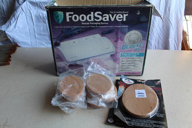 lot 6131 image: FoodSaver Unit is the original box and Magnetic Trivets  - in original packaging