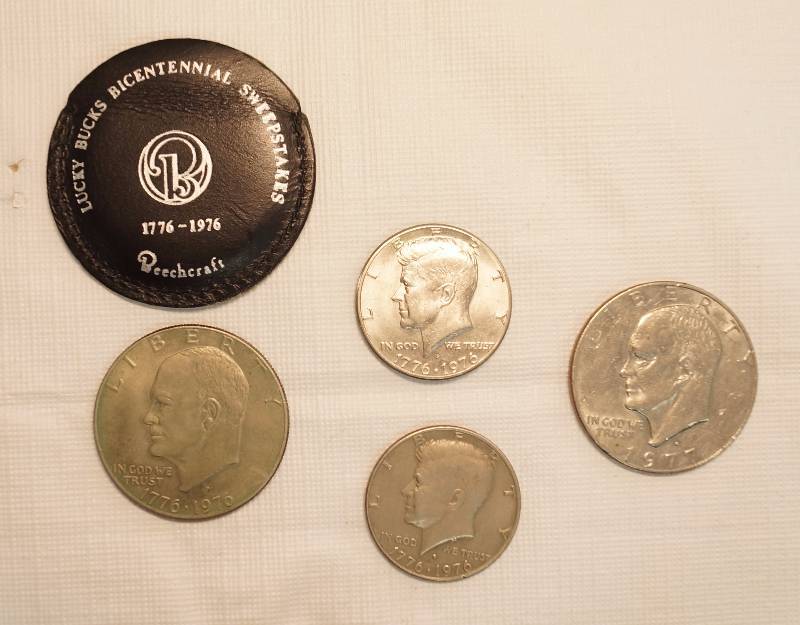 lot 4583 image: Lot of 4 Coins - 2 IKE Dollars - 1 Bicentennial 1776-1976 w Beechcraft Holder & 1977 Beechcraft Holder & 2 Kennedy Half Dollars