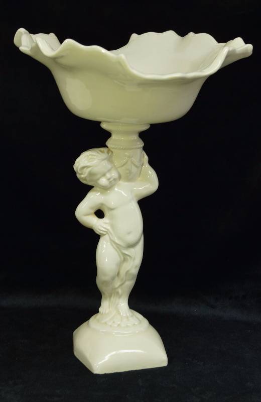 lot 1276 image: Very pretty elevated dish held by a little cherub boy - 14 tall - small chip on the back edge see photo