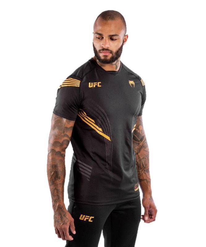 lot 15767 image: Venum Mens Standard UFC Authentic Fight Night Walkout Jersey, BlackGold, Small Size.