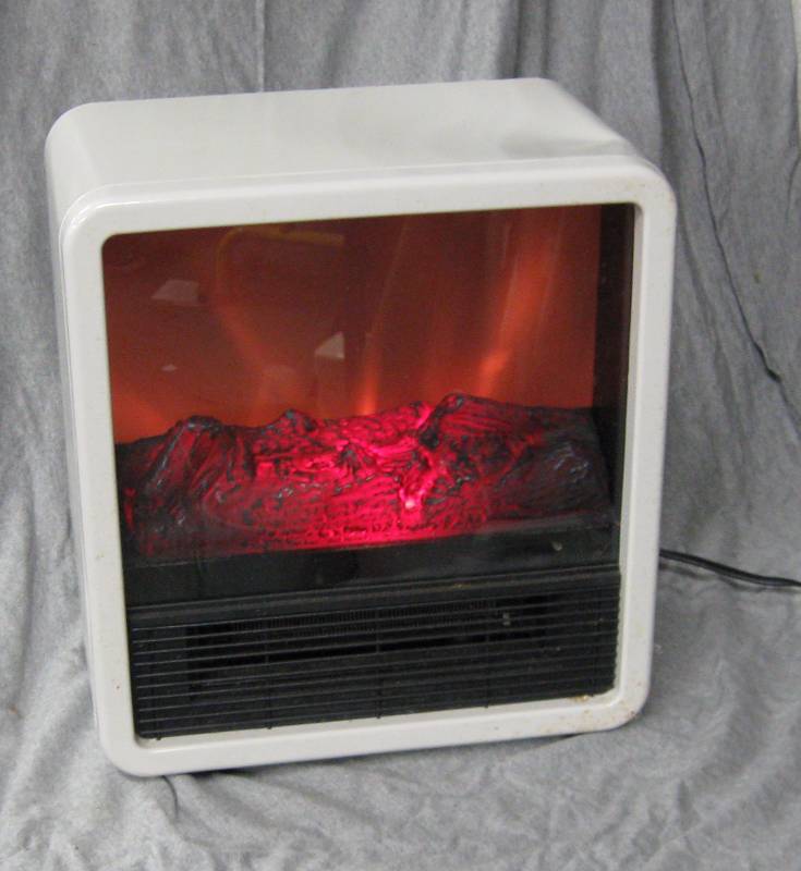lot 2570 image: Electric Fireplace - New - M# DFS-300-WHT 750w or 1500w settings - has dent on top (see photo) 13 x 8 x 14.75 tall - packaging missing