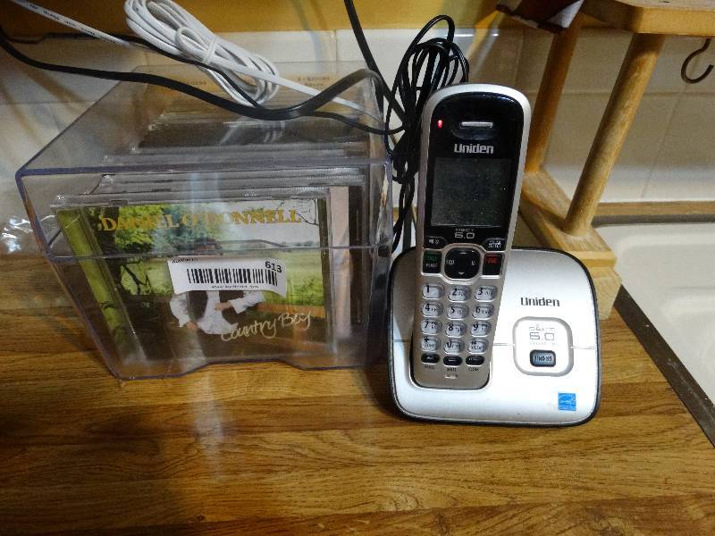 lot 613 image: Lot of various CDs, cordless phone, over sink wood rack.