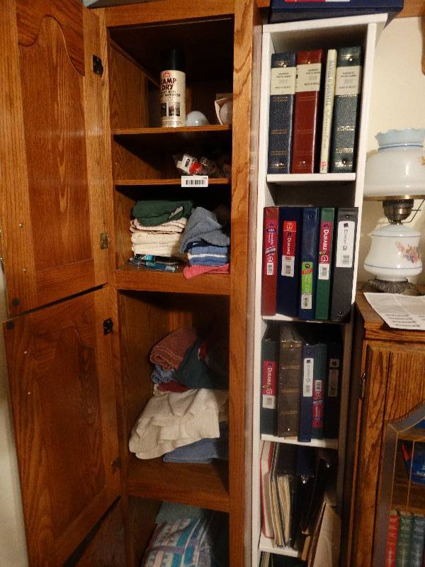 lot 956 image: Contents of Cabinets - Towels, Binders, Light bulbs, & misc.