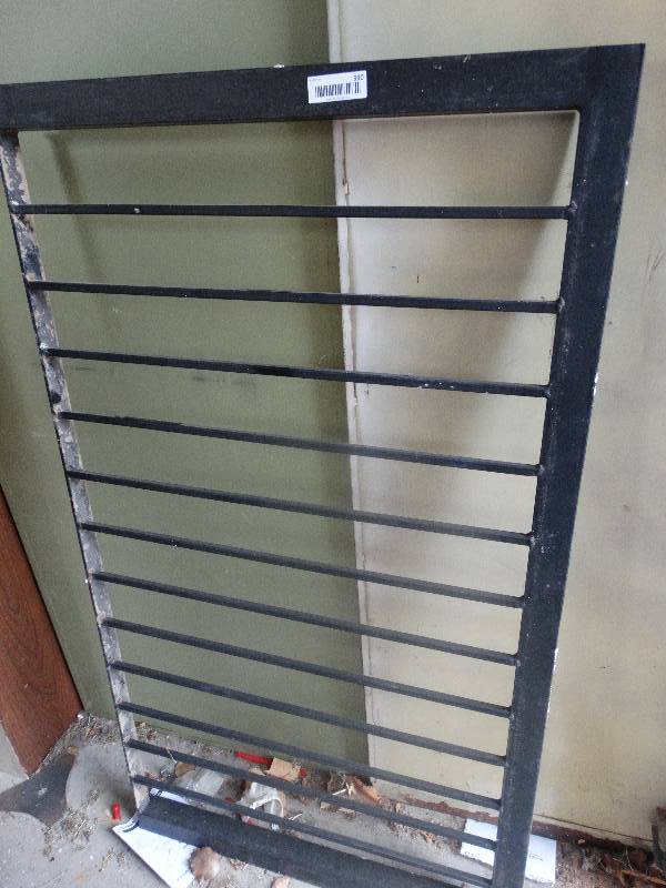 lot 990 image: Metal grate for egress window access