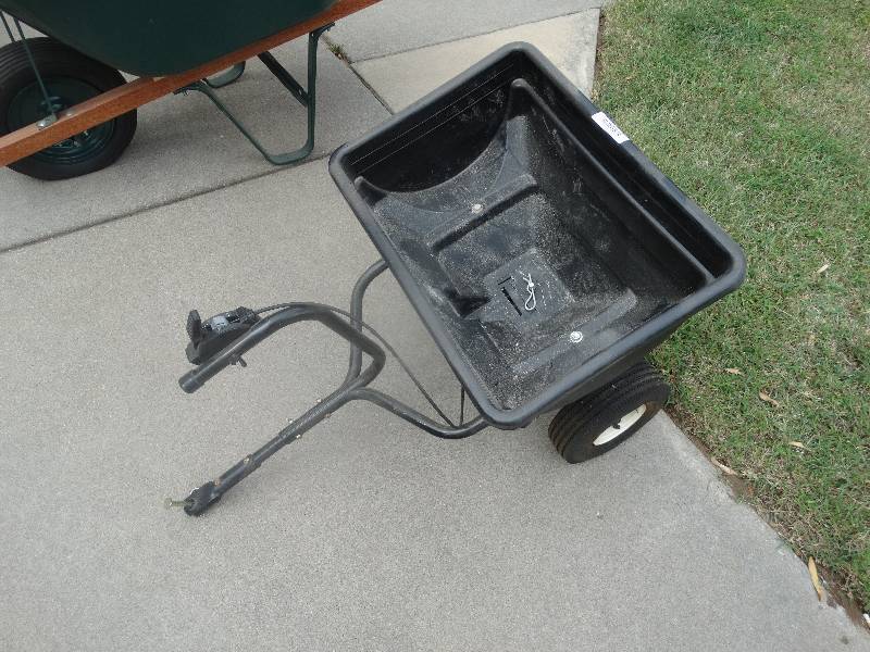 lot 1653 image: Pull behind broadcast spreader for riding lawn mower