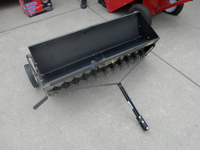 lot 1655 image: Pull behind seeder for riding lawn mower- Like New