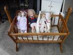 3 dolls and wooden cradle