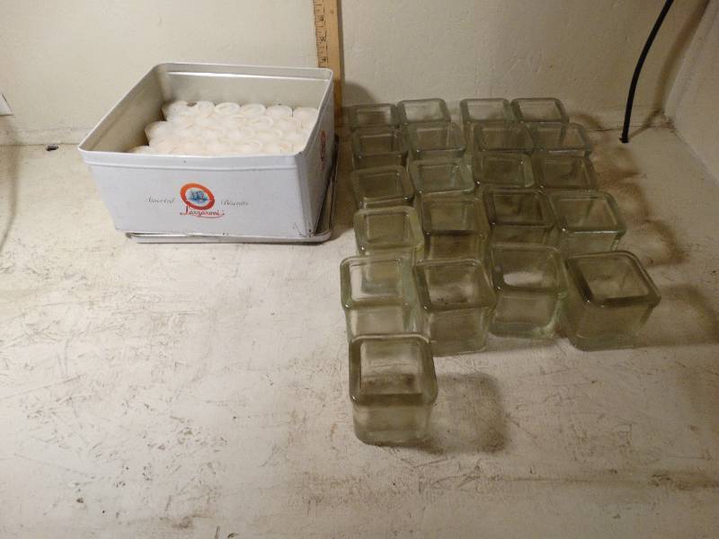 lot 149 image: 21- Glass candle holders and a tin full of candles.