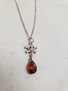 lot 6856 image: Small Silver Skull and Crossbones with Amber Jewel Necklace