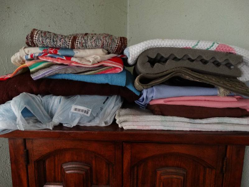 lot 447 image: Assorted blankets & rugs (Armoire not included).