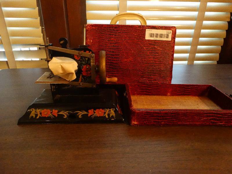 lot 113 image: Mini Vintage Salesman special sewing machine.