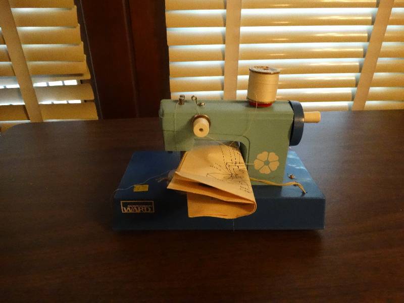 lot 126 image: Mini Vintage Montgomery ward sewing machine.