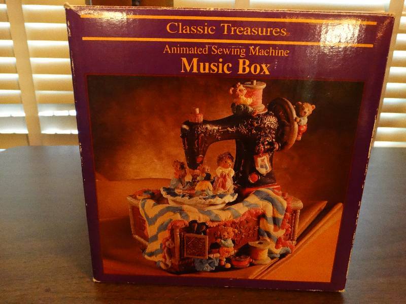 lot 170 image: Sewing machine decor music box.
