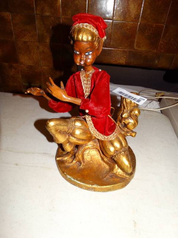 lot 209 image: vintage flute player. missing flute.