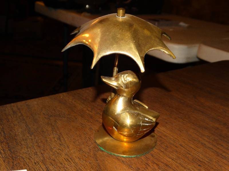 lot 232 image: Brass Duck with umbrella.