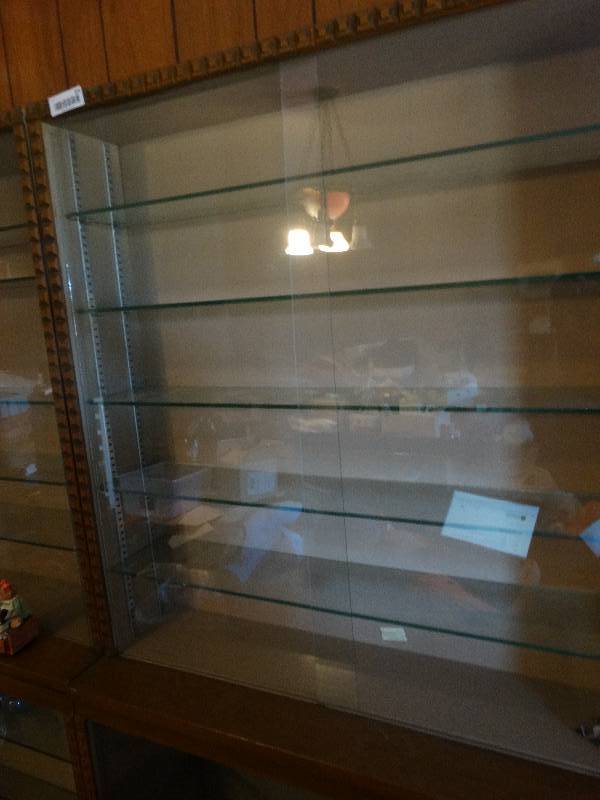 lot 324 image: 2 piece glass case w8 glass shelves, chip in one of the glass doors.