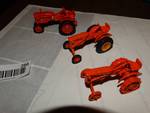 3- Orange mini tractors.