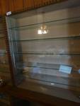 2 piece glass case w/8 glass shelves, chip in one of the glass doors.