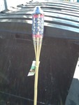 Five new six-foot tall tiki torches with patriotic flag pattern bamboo top as pictured