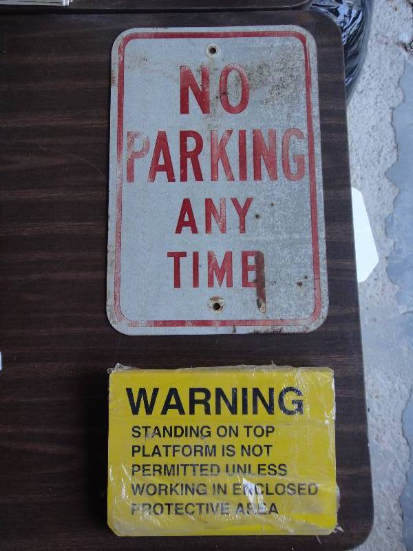 lot 2208 image: Metal No Parking Any Time sign and a stack of wrappednew metal Warning Signs