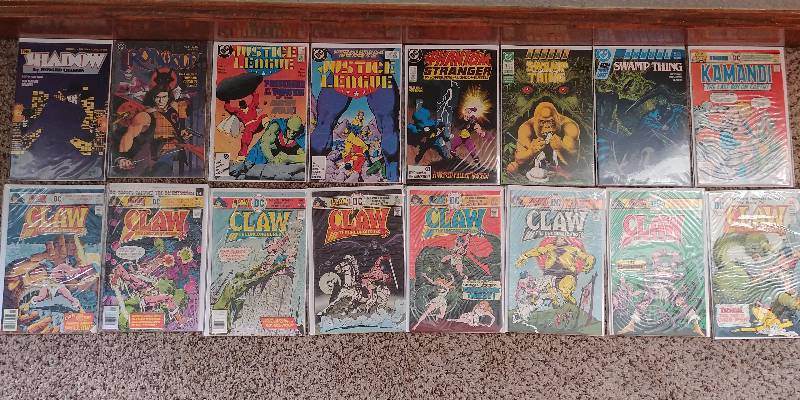 lot 319 image: DC Comic Book Lot The Shadow, Justice League, Phantom Stranger, Swamp Thing, The Claw, Kamandi