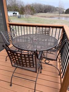 lot 1031 image: Wrought iron patio table with 4 chairs