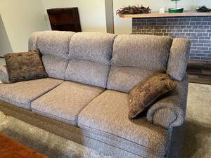 lot 2030 image: Neutral toned, three section couch with pillows 36 x 84 x 40 Located in the basement