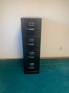 lot 2045 image: 4 drawer black metal filing cabinet. 52 x 15 x 25. Located in the basement