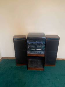 lot 2046 image: Soundesign AM FM receiver with double deck cassette player and record player with speakers. Stereo is 33 x 16 x 13.5. Speakers are 31 x 11 x 8. Located in the basement Radio does work