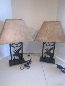 lot 2204 image: Table top lamp. Approximately 22 inches tall. They both have moose and tree cut outs