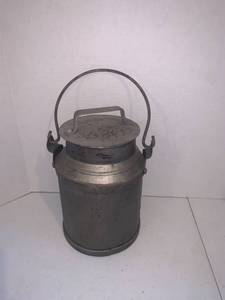 lot 2223 image: Metal milk can. Approximately 10 inches tall