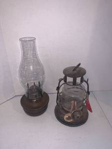 lot 2226 image: An oil lamp and candle holder lantern. Tallest is 12 inches