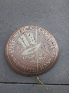 lot 3009 image: Round metal Prestige Coach sign. Approximately 25 inches diameter