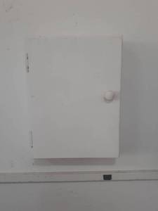 lot 3039 image: Wooden storage box with drill bits and more. Winner will need to remove from wall. Bring the needed tools