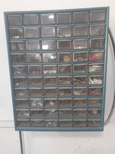 lot 3040 image: 60 drawer storage bin plus contents. Needs to be removed from wall