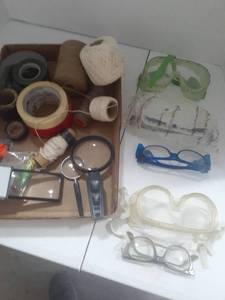 lot 3130 image: Tape, safety glasses, string, ear plugs and magnifying glasses