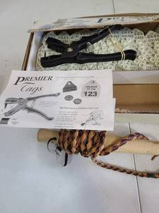 lot 3242 image: Sheep ear tags and a whip