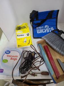 lot 3323 image: Vacuum bags and vacuum attachments, extension cords, visit Wichita bag, broom end