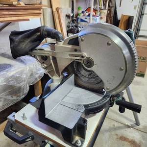lot 3605 image: Ryobi saw stand with compound miter saw. includes heavy duty power cords