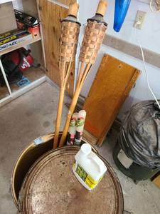 lot 3801 image: 30 inch tall cardboard barrel with Tiki torches, citronella lawn candle torches, citronella outdoor lamp oil