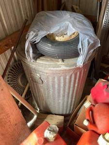 lot 4041 image: Galvanized trash can with wheel barrow tire