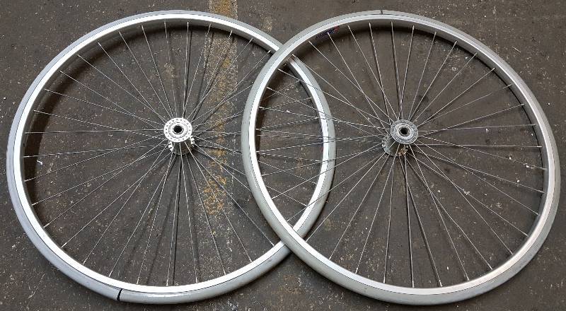lot 6160 image: Pair of 27 OD  58 spindle bearings high speed spoke wheels and hard rubber tires
