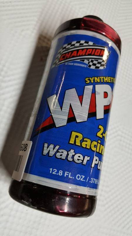 lot 6608 image: New bottle of Champion 2 cycle racing engines special water pump lubricant
