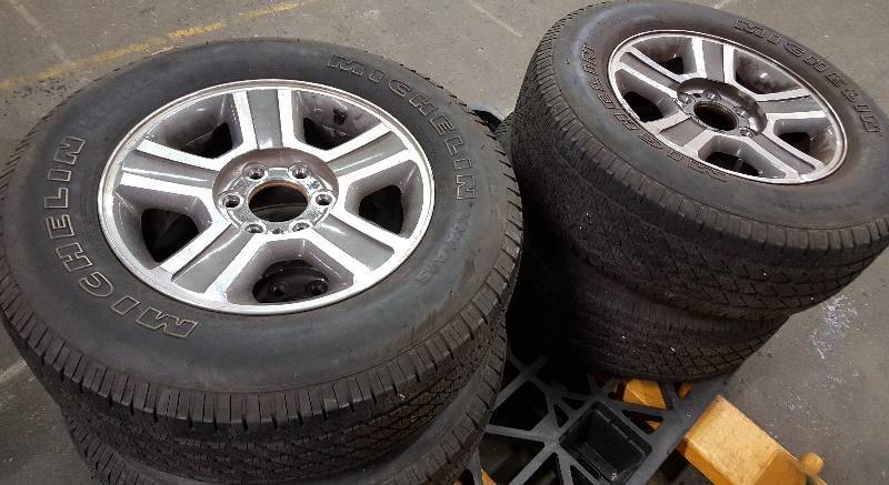 lot 6100 image: Nice set of 4 FoMoCo 6 lug pick up truck P25565R17 Michelin tires and factory alloy wheels.