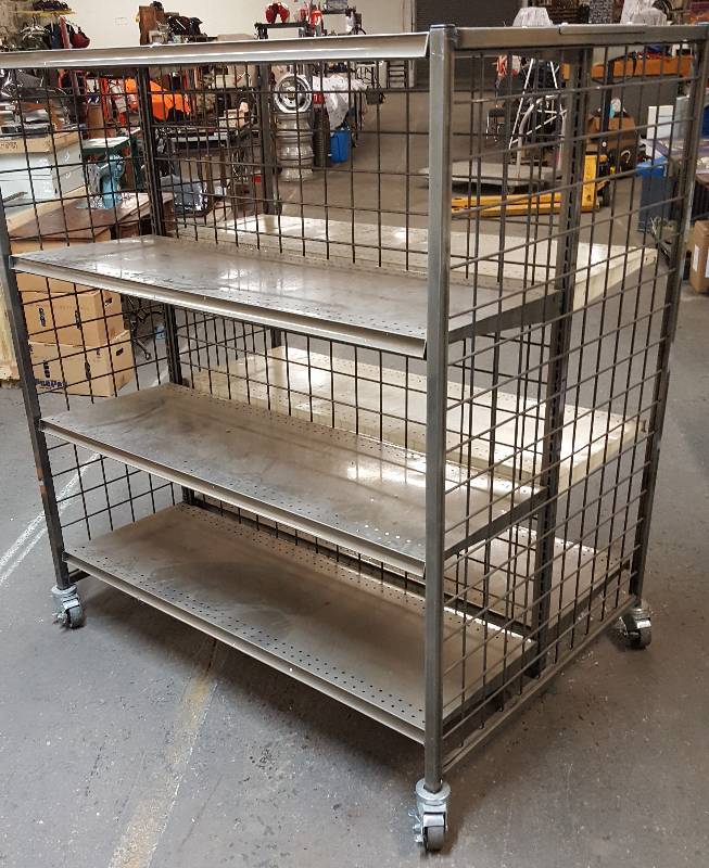 lot 6106 image: Retail display rack on swivel casters with adjustable shelves and double sided.  51 wide, 57 tall