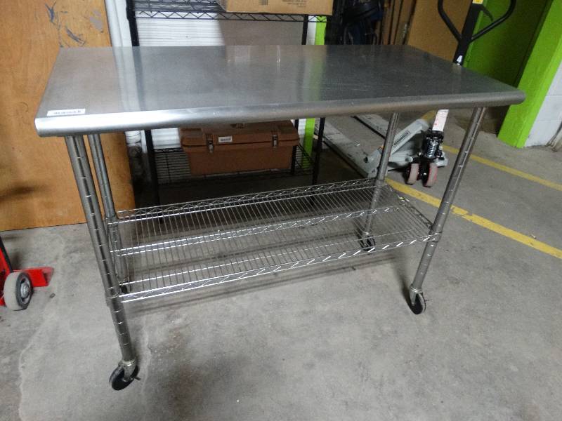 lot 151 image: Metro style stainless steel table w under shelf on wheels.