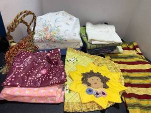 lot 44440 image: Linens- Queen flat sheet and Twin set, 2 table clothes, pillow cases, table runner, placemat and pot holder